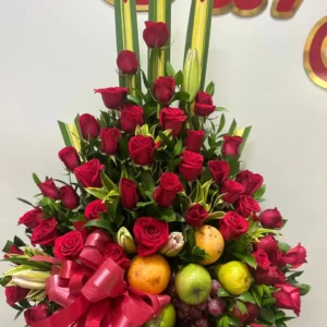 Arreglo floral piramide con rosas rojas y frutas