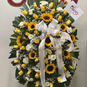 Corona funebre con claveles y girasoles