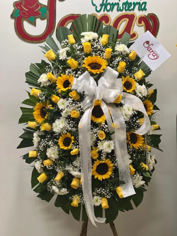 Corona funebre con claveles y girasoles