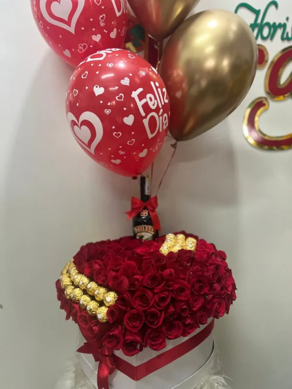 Caja corazon con rosas rojas, chocolates Ferrero Rocher, botella de Bailey's y globos con helio