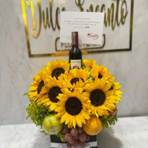 Caja con girasoles, frutas y botella de Bailey's