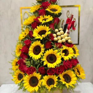 Arreglo floral con rosas, girasoles, chocolates Ferrero Rocher y botella de Bailey's